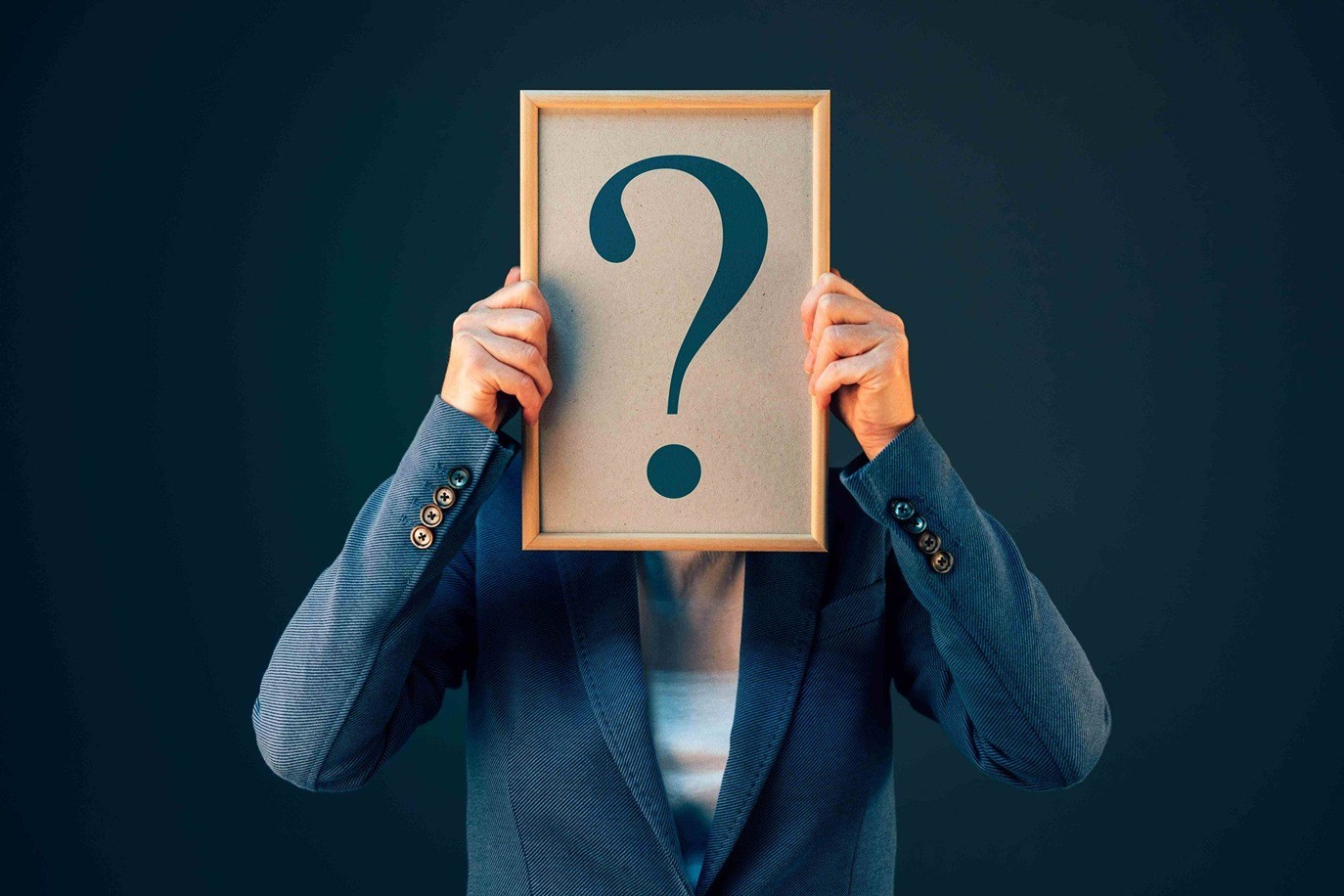 A person holding a cardboard with question mark.