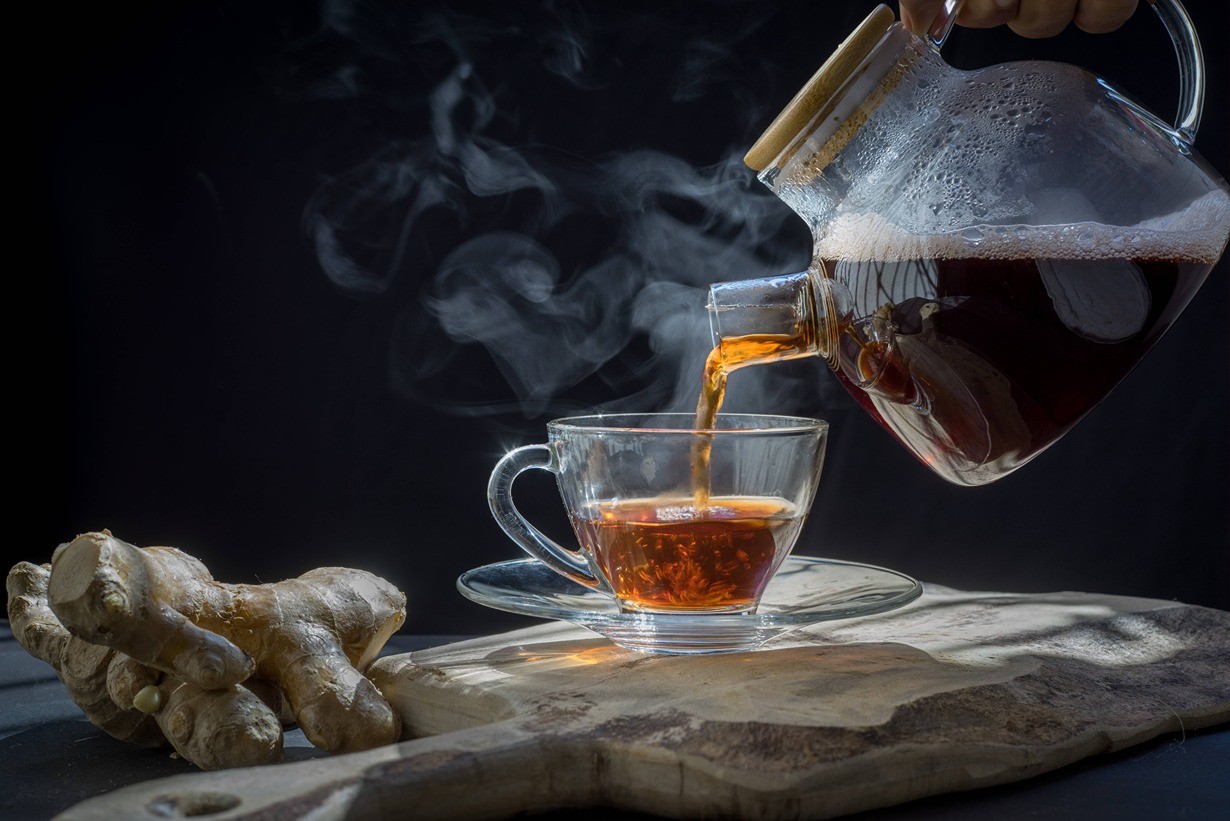 Pouring tea into a tea mug.