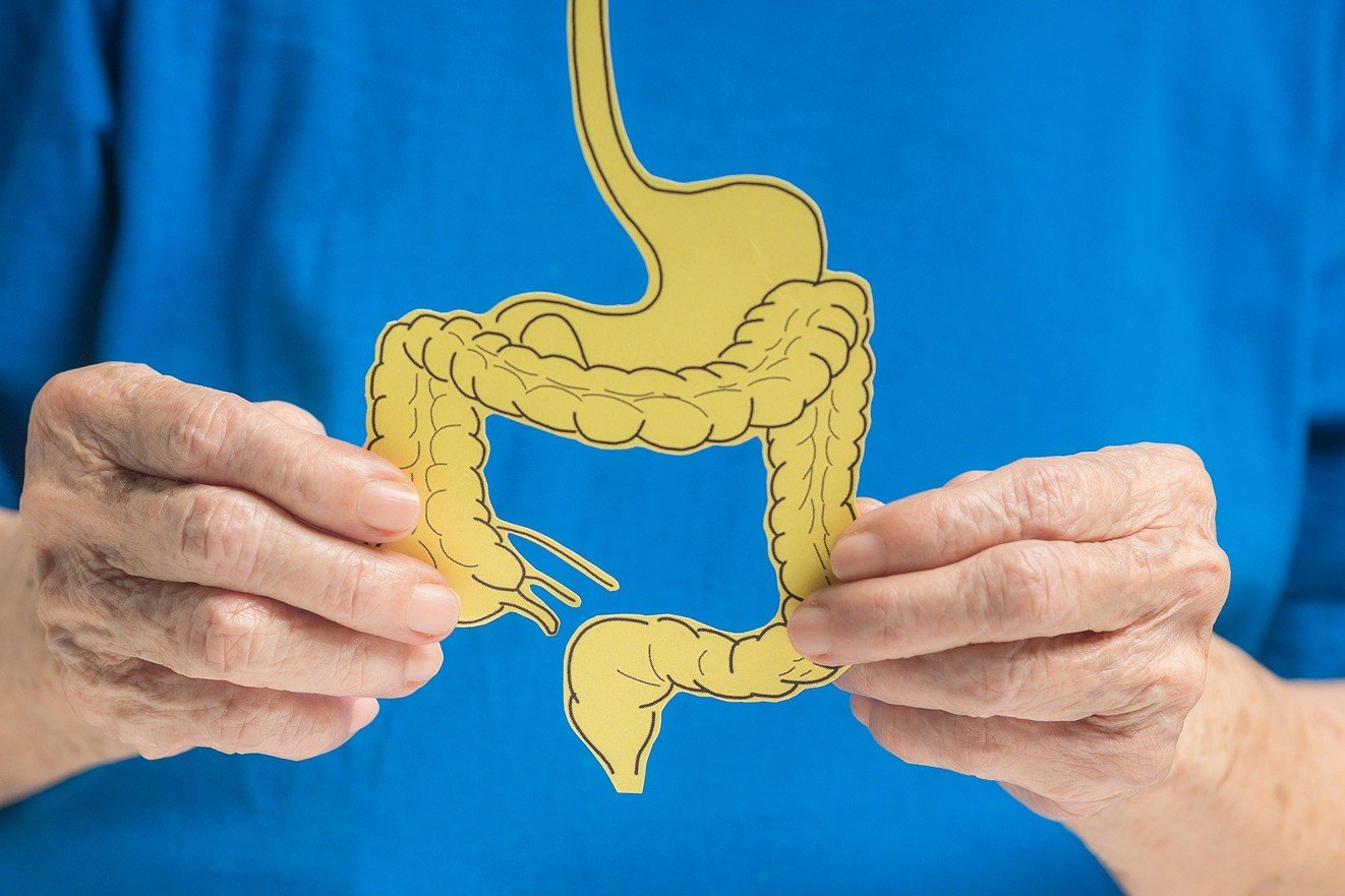 Old man holding a paper picture of a bowel.