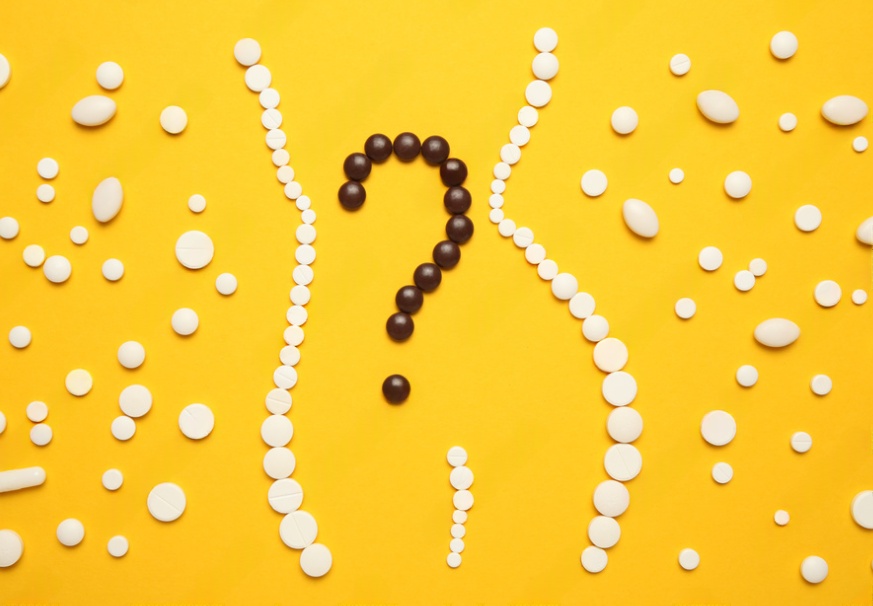 Tablets organised in the shape of a body on a yellow background with question mark in the centre.